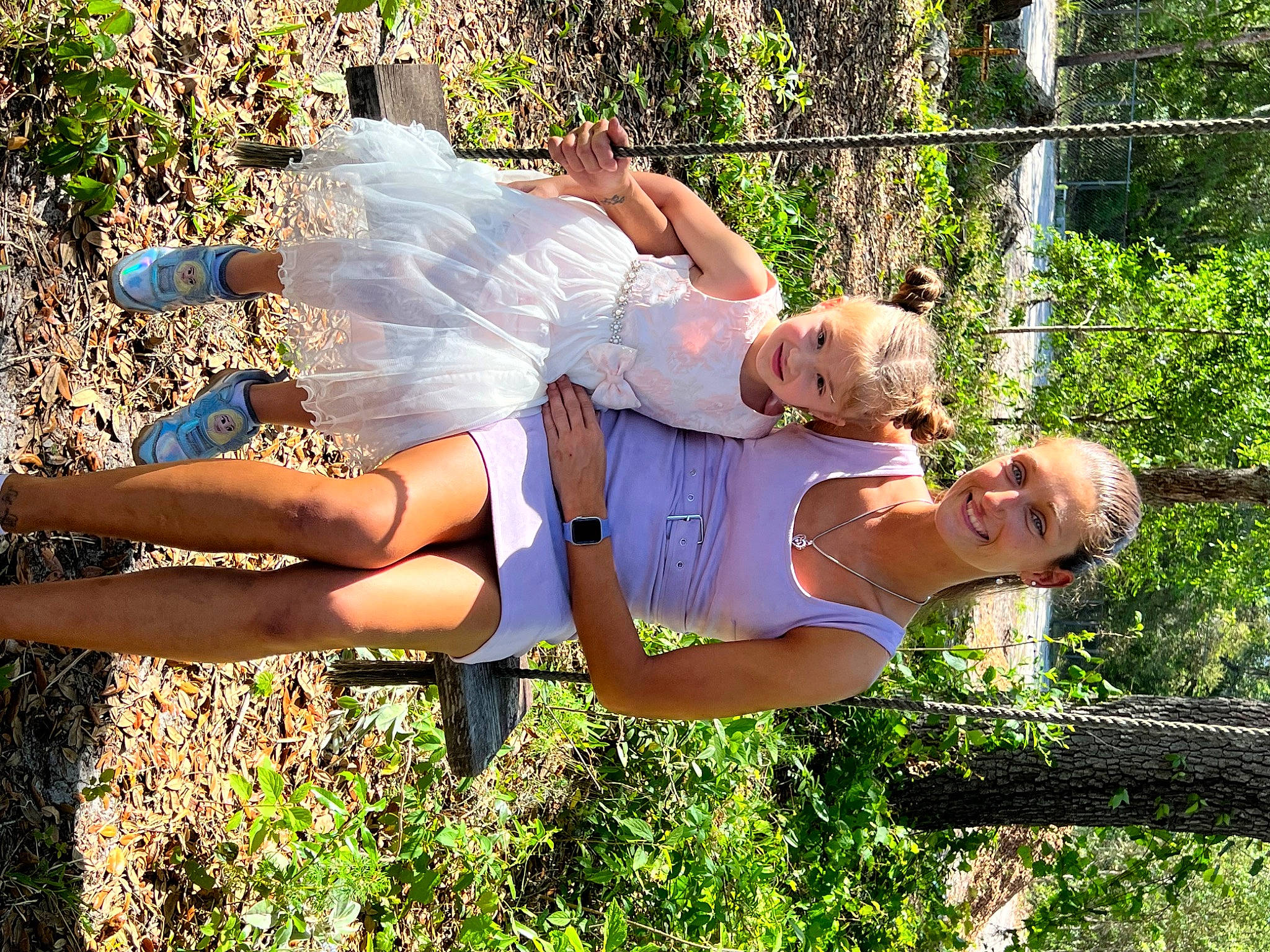 Hailey is registered to the contest to win money with this photo: abdomen, blond, electric_blue, flash_photography, fun, grass, happy, human_leg, joy, knee, leisure, people_in_nature, person, plant, recreation, shorts, sitting, smile, thigh, tree