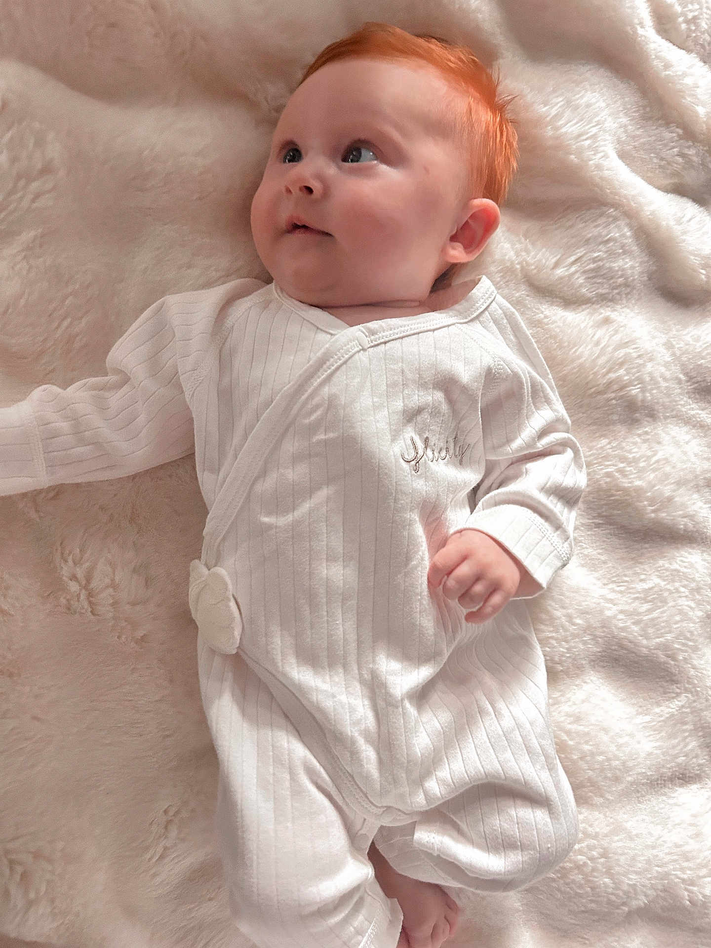 Felicity joined the competition — help win amazing prizes! baby, infant, red_hair, white_onesie, blanket, soft_texture, lying_down, cute, child, portrait, face, skin, hand, foot, sleepwear, cozy, innocence, looking_up, comfort, young