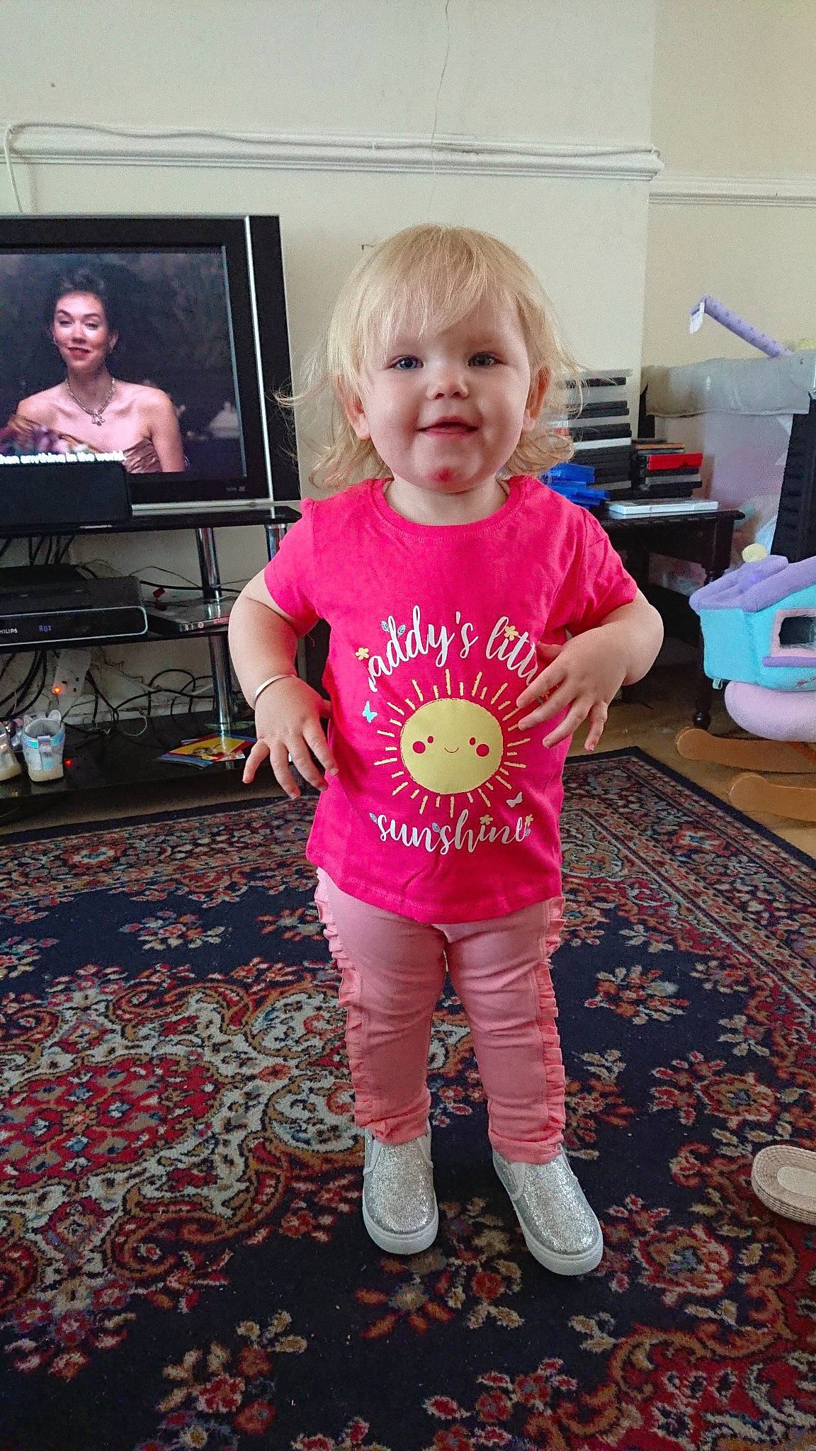 Rebecca is registered to the contest to win money with this photo: arm, baby_toddler_clothing, child, leg, person, pink, play, standing, t_shirt, toddler