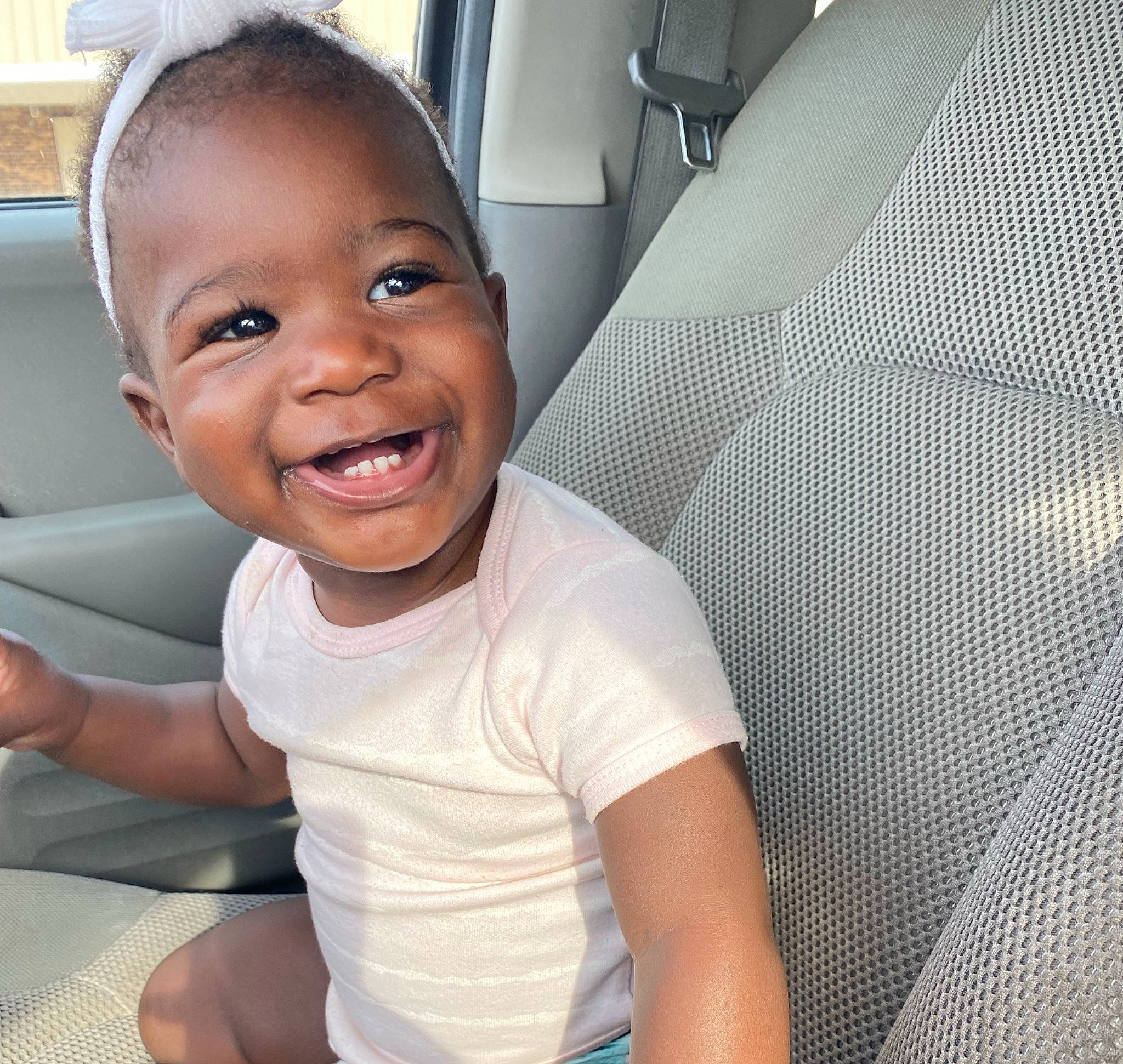 Ayla is registered to the contest to win money with this photo: auto_part, automotive_exterior, car_seat, cheek, chest, comfort, cool, eyebrow, fun, happy, jaw, mouth, muscle, nose, person, sleeve, smile, t_shirt, toddler, vehicle_door