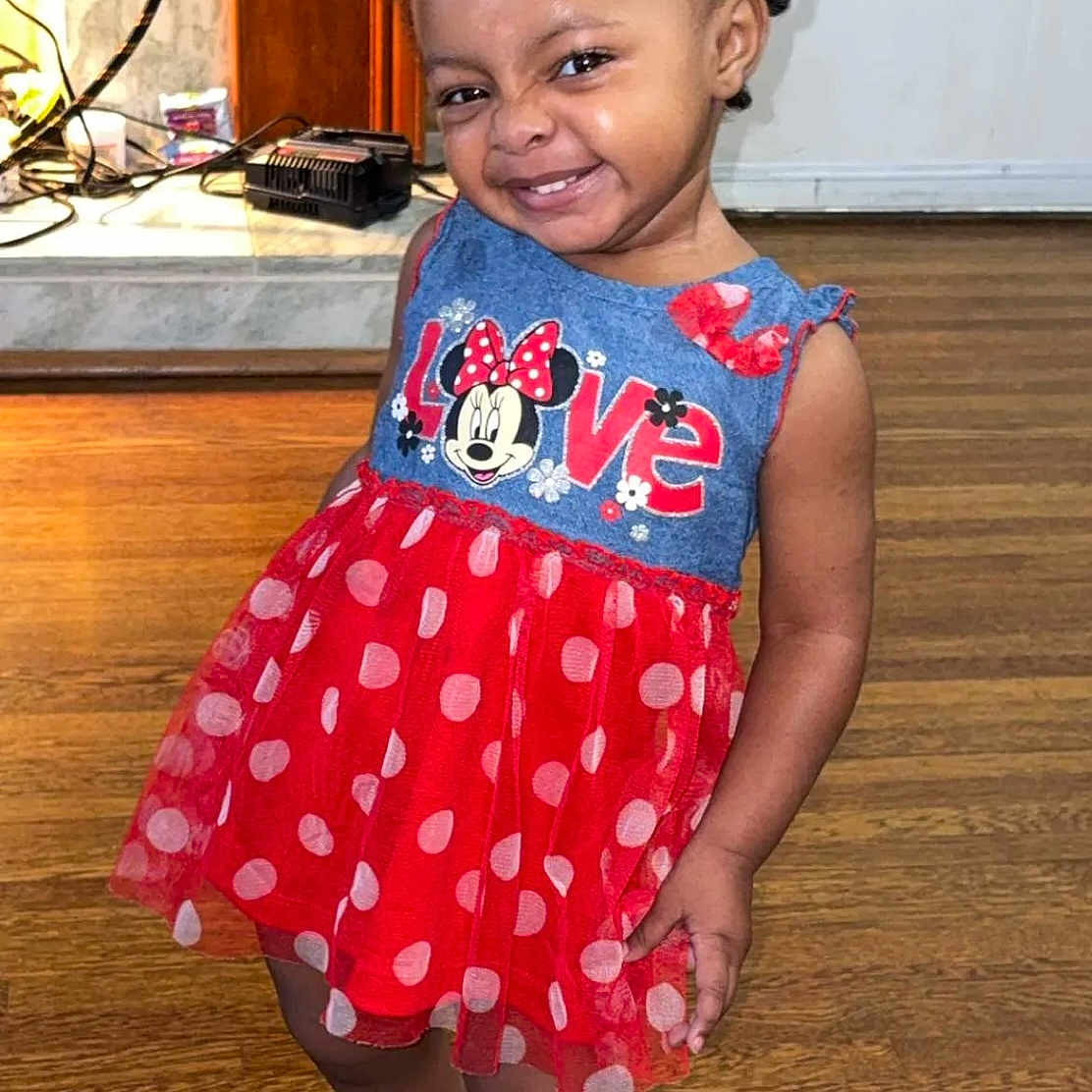 Saaliyah is registered to the contest to win money with this photo: blue, child, cute, dress, fashion, hair_buns, happy, indoor, minnie_mouse, person, playful, polka_dots, portrait, red, silver_shoes, smiling, standing, toddler, wood_floor, young_child