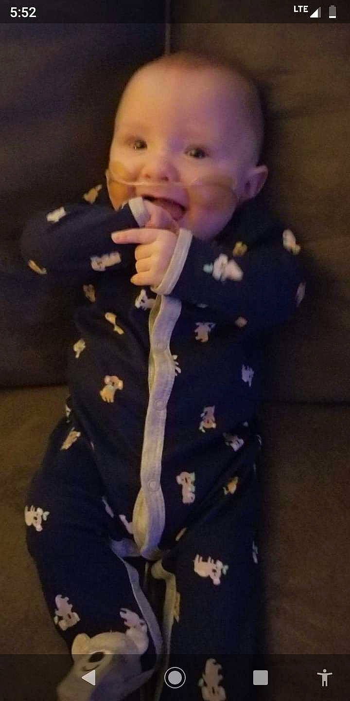 Leighton is registered to the contest to win money with this photo: baby, baby_toddler_clothing, cheek, child, dress_shirt, eye, eyebrow, formal_wear, fun, gesture, happy, head, iris, pattern, person, sleeve, smile, suit, thumb, toddler