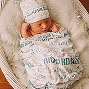 Richard joined the competition — help win amazing prizes! baby, basket, bed, blanket, bonnet, clothing, crib, face, furniture, hat, head, infantbed, newborn, person, photography, portrait, sleeping