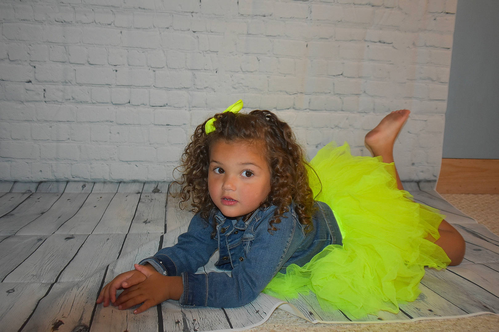 Paisley is registered to the contest to win money with this photo: child, denim, fashion_accessory, flash_photography, floor, flooring, fun, fur, grass, hair_accessory, happy, headband, headpiece, person, road_surface, sitting, soil, toddler, wood