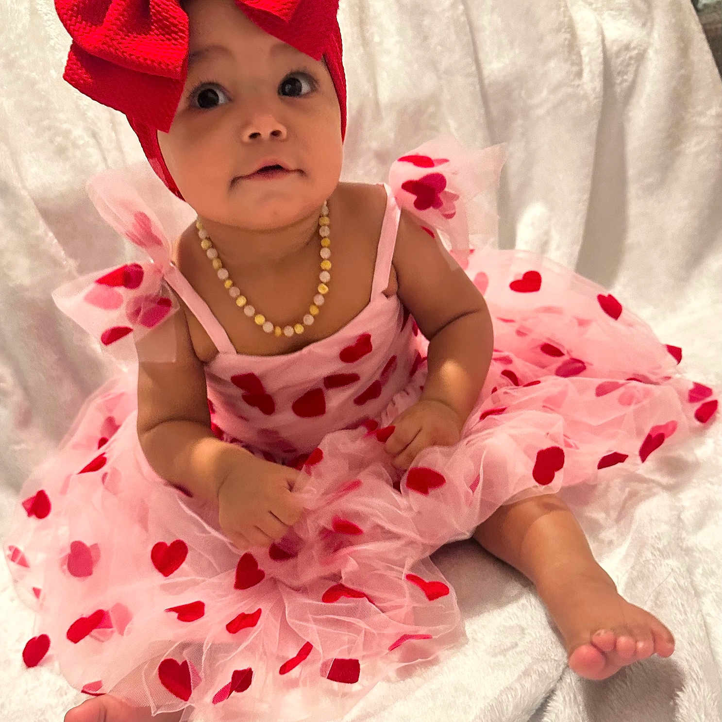 Zuriyah joined the competition — help win amazing prizes! accessories, baby, bonnet, cap, clothing, costume, dress, face, hair, happy, hat, head, jewelry, necklace, person, photography, portrait, sitting, sleeve, smile