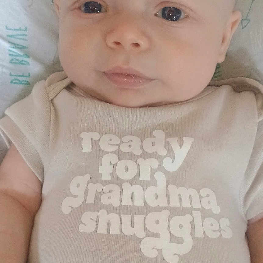 Hudson is registered to the contest to win money with this photo: baby, clothing, cushion, face, frown, furniture, happy, head, homedecor, jeans, newborn, pants, person, photography, portrait, shirt, sleeping, sleeve, smile, t_shirt