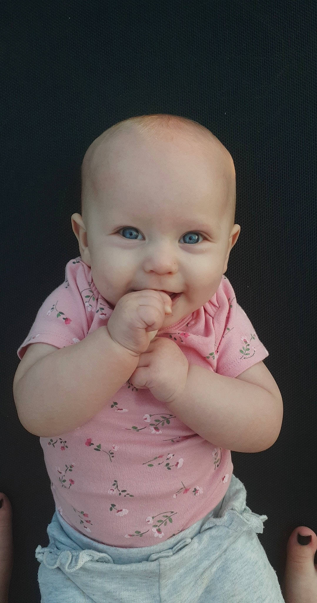 Emmalyn is registered to the contest to win money with this photo: arm, baby, baby_toddler_clothing, cheek, chin, eye, finger, gesture, hairstyle, hand, happy, iris, joint, lip, mouth, nose, person, pink, skin, sleeve