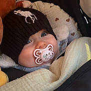 élio a rejoint le concours — aidez-le/la à gagner de superbes lots ! baby, infant, pacifier, beanie, knit_hat, stroller, blanket, plush_toy, close_up, portrait, bundled, cheeks, big_eyes, soother, cozy, heart_pattern, soft_toy, winter_clothing, baby_carriage, adorable