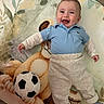 élio a rejoint le concours — aidez-le/la à gagner de superbes lots ! baby, blanket, blue_shirt, cheeks, cute, eyes, face, happy, infant, lying_down, nursery_mat, pacifier, pants, plush_toy, polo_shirt, portrait, smiling, soccer_ball, socks, wooden_floor