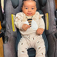 Carla Salazar is registered to the contest to win money with this photo: baby, child, car_seat, infant, braided_hair, cute, smiling, clothing, bee_pattern, socks, indoor, seat, person, cute_outfit, comfort, happy, young_child, portrait, casual, cozy