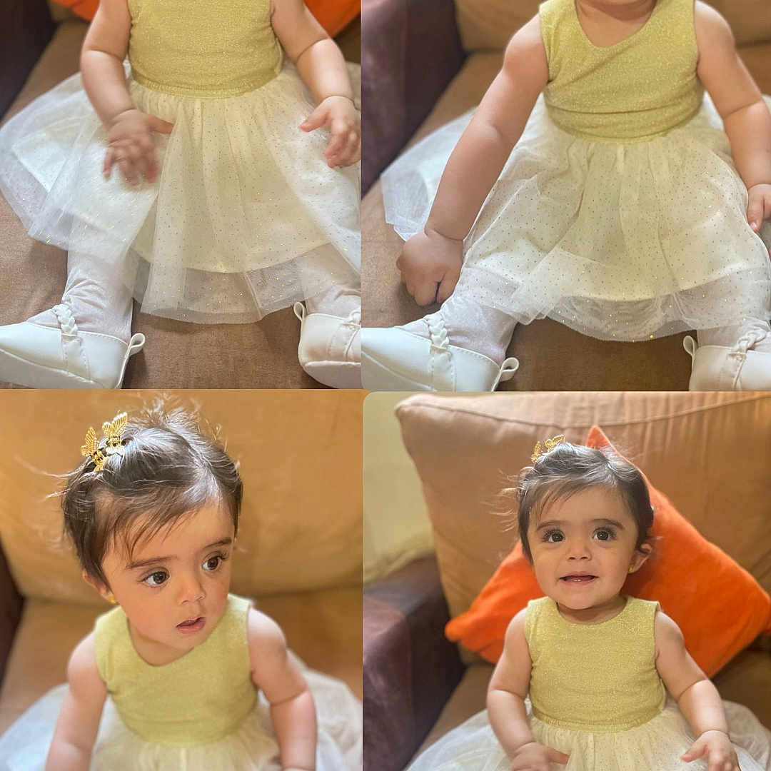 Talya is registered to the contest to win money with this photo: baby_shoes, child, comfortable, couch, curious, cute, dress, girl, gold, hair_clip, happy, indoors, orange_pillow, portrait, sitting, smiling, sparkly, toddler, white, young_child
