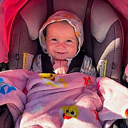 Azalea joined the competition — help win amazing prizes! baby, blue_eyes, car_seat, child, cozy, cute, duck_pattern, hood, hooded_jacket, infant, outdoor, pink_blanket, portrait, rosy_cheeks, safety_harness, seat_padding, smiling, star_pattern, stroller_canopy, sunlight