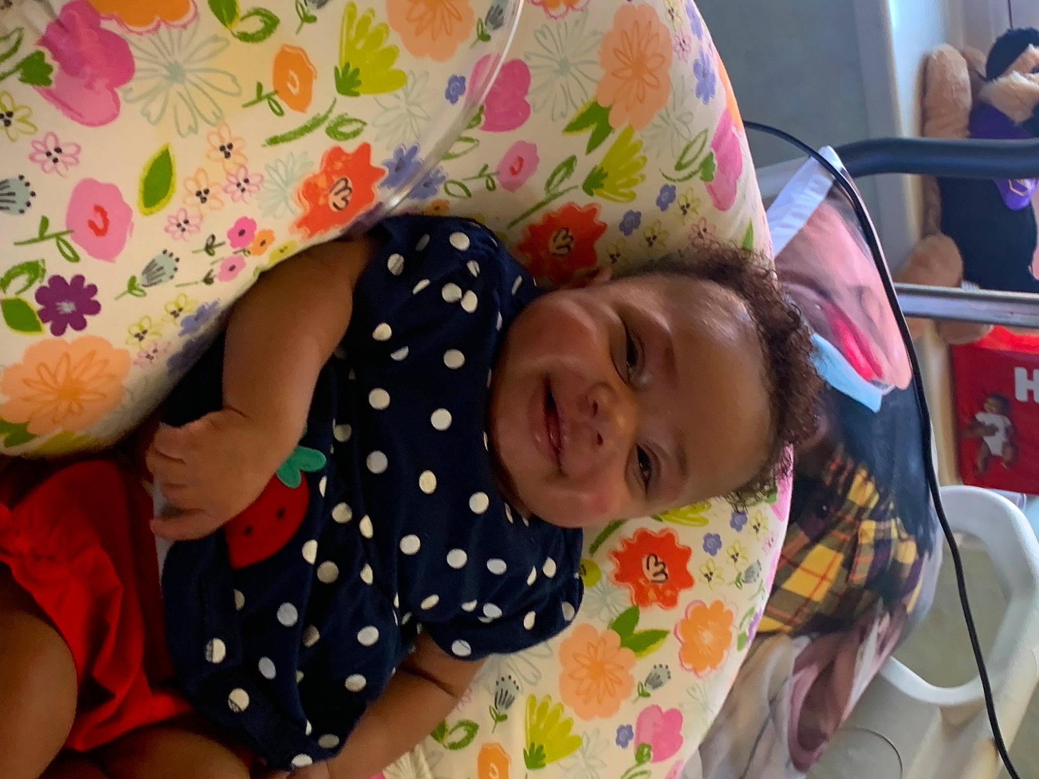 Alana is registered to the contest to win money with this photo: baby, baby_products, baby_toddler_clothing, car_seat, cheek, child, comfort, facial_expression, fun, happy, linens, pattern, person, pink, room, skin, sleeve, smile, t_shirt, toddler