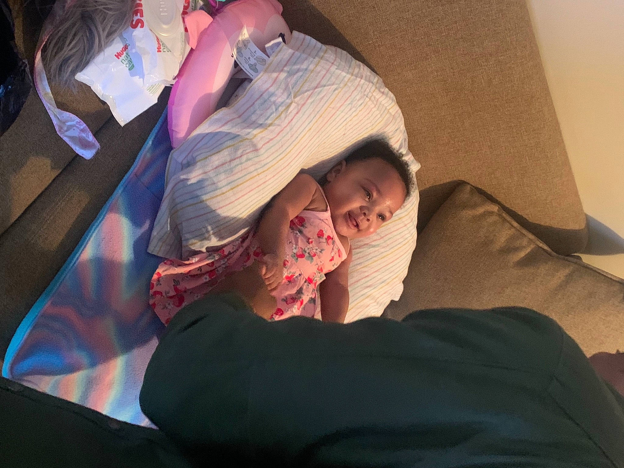 Alana is registered to the contest to win money with this photo: child, comfort, elbow, event, finger, flesh, fun, gesture, happy, human, human_leg, linens, magenta, mouth, nap, person, room, sitting, smile, textile