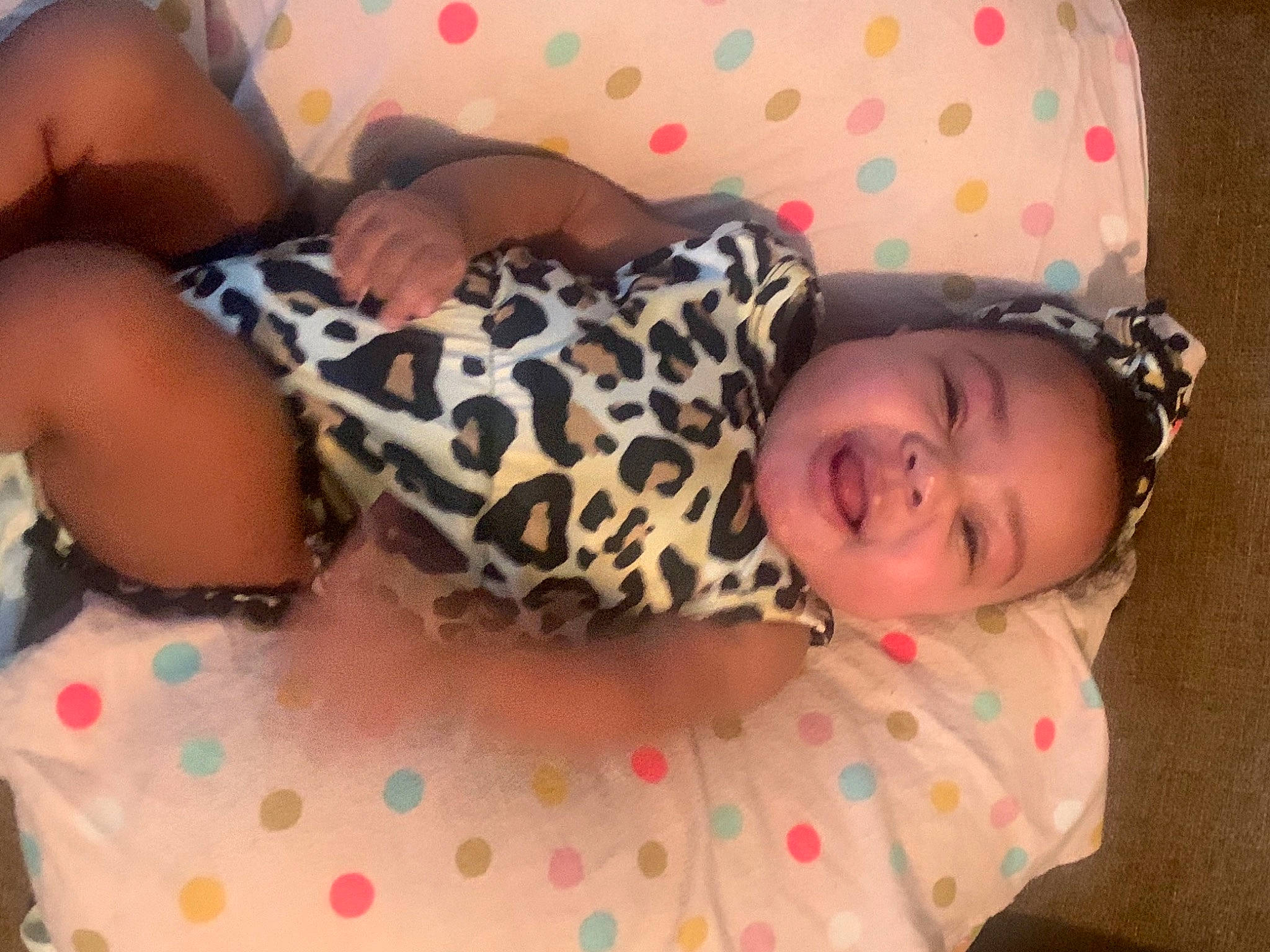 Alana is registered to the contest to win money with this photo: baby, baby_toddler_clothing, cheek, child, comfort, couch, eye, finger, head, human_body, leg, linens, pattern, person, pink, skin, smile, textile, thigh, toddler