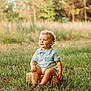 toddler, child, grass, outdoor, nature, basket, curly_hair, blue_eyes, sunlight, portrait, sitting, greenery, field, casual_clothing, shorts, summer, cute, baby, happy, innocent