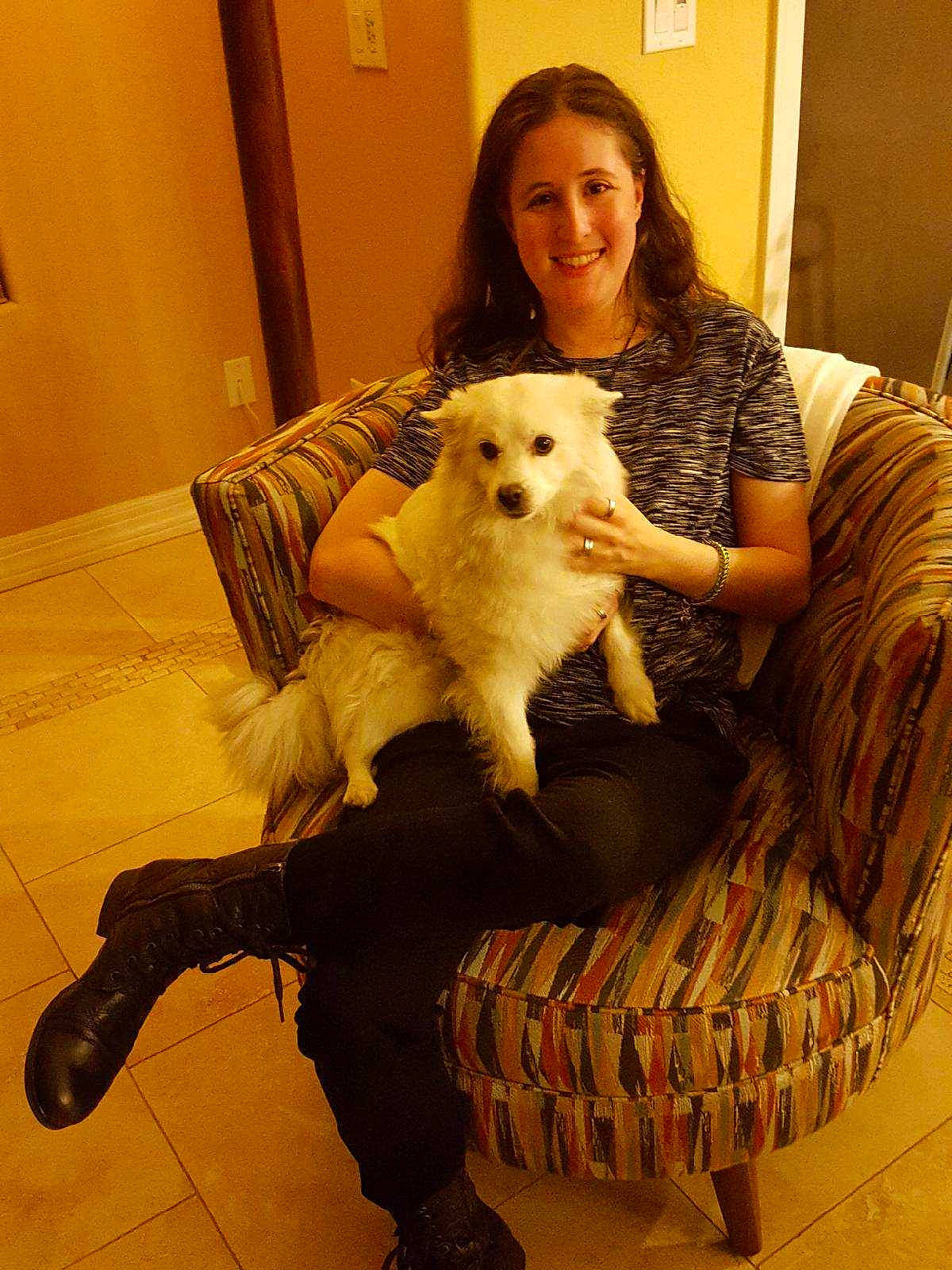 Akela is registered to the contest to win money with this photo: carnivoran, companion_dog, dog, dog_breed, dog_breed_group, dog_like_mammal, flooring, fun, fur, girl, joy, mammal, person, pomeranian, puppy, skin, smile, textile, vertebrate