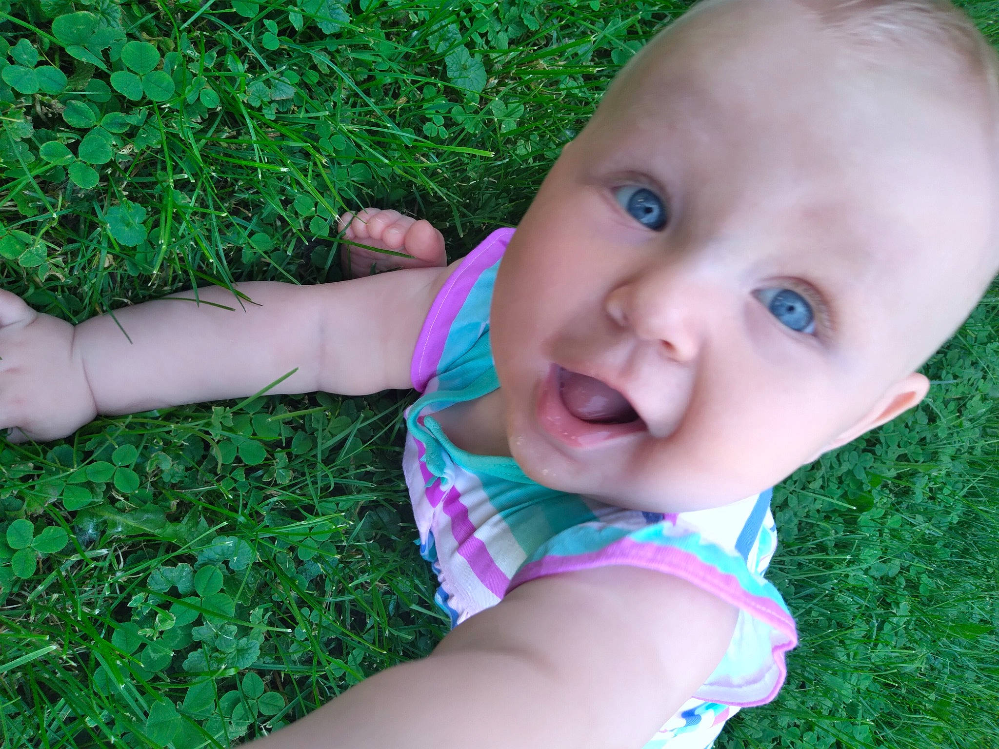 Jurney is registered to the contest to win money with this photo: baby, baby_toddler_clothing, botany, cheek, facial_expression, finger, grass, green, happy, human_body, iris, leaf, lip, mouth, nose, people_in_nature, person, plant, skin, smile