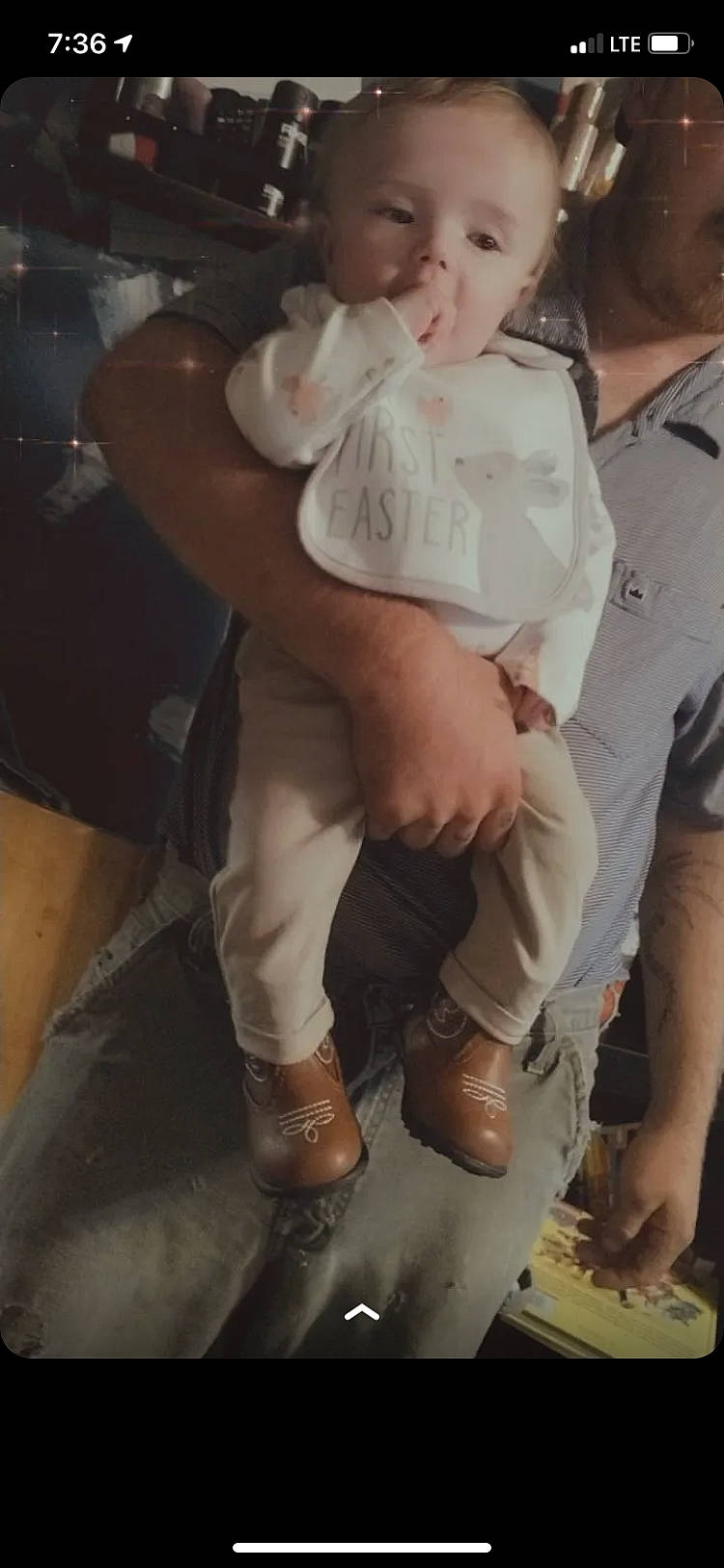 Lewis is registered to the contest to win money with this photo: abdomen, baby, belt, chest, event, formal_wear, fun, gesture, happy, hug, human_leg, joint, knee, person, sandal, shorts, sitting, soldier, thigh, toddler