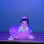 Azalea joined the competition — help win amazing prizes! baby, girl, tutu, purple, headband, bench, crawling, smile, child, indoor, portrait, cute, clothing, hands, feet, wood, floor, blue_background, infant, young