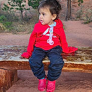 Luna joined the competition — help win amazing prizes! bench, casual, child, clothing, curious, daylight, desert, ground, nature, outdoor, pacifier, person, portrait, red_crocs, red_hoodie, rock, sitting, toddler, tree, young_child