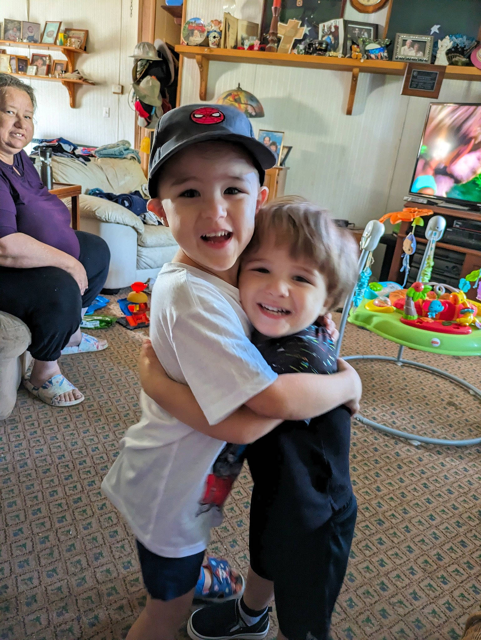 Colter joined the competition — help win amazing prizes! baseball_cap, cap, child, event, fun, happy, hat, headwear, joy, leg, leisure, person, picture_frame, public_space, recreation, sandal, shelf, shorts, smile, standing