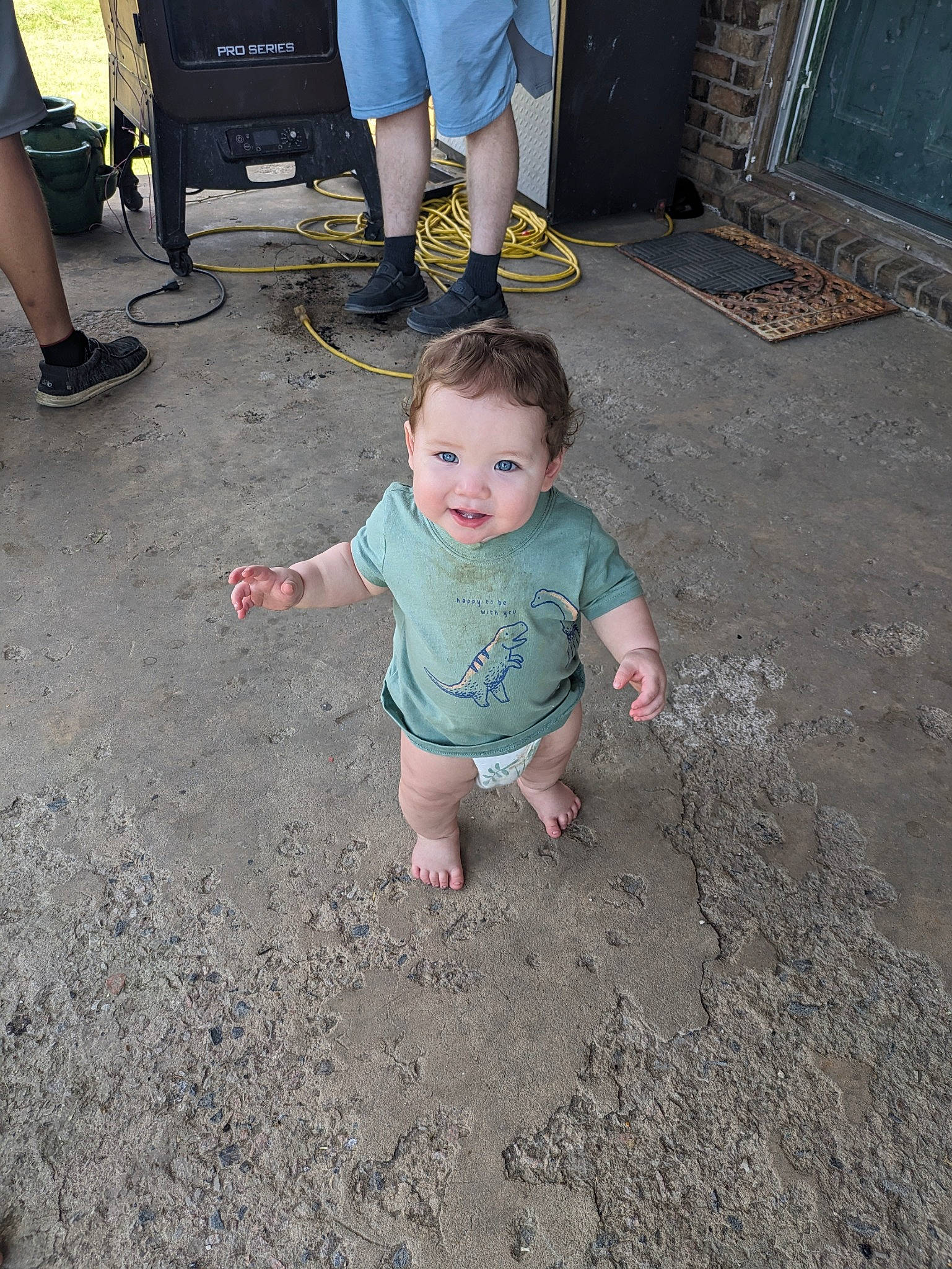 Bentley is registered to the contest to win money with this photo: asphalt, baby, barefoot, child, event, floor, flooring, foot, fun, grass, human, leg, person, road_surface, shorts, sidewalk, soil, t_shirt, thigh, toddler