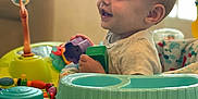 Kyl joined the competition — help win amazing prizes! activity_center, baby, child, clothing, colorful, cute, face, furniture, hand, happy, head, indoor, infant, living_room, person, play, seat, smiling, toy, young_child
