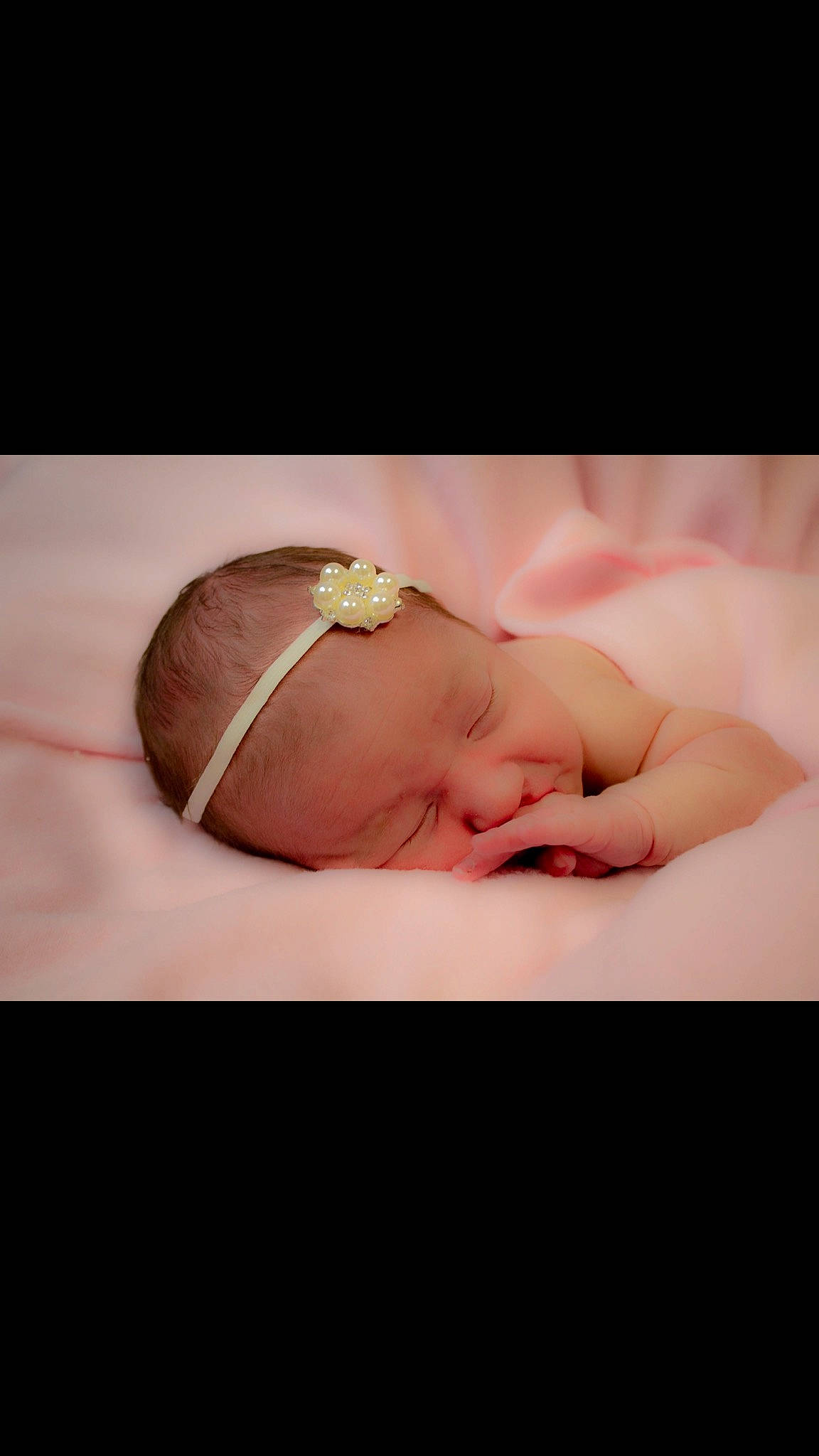 Prudence is registered to the contest to win money with this photo: baby, bedtime, cheek, child, close_up, eye, face, hair_accessory, hand, head, headband, headgear, lip, mouth, nose, person, photography, pink, skin, sleep