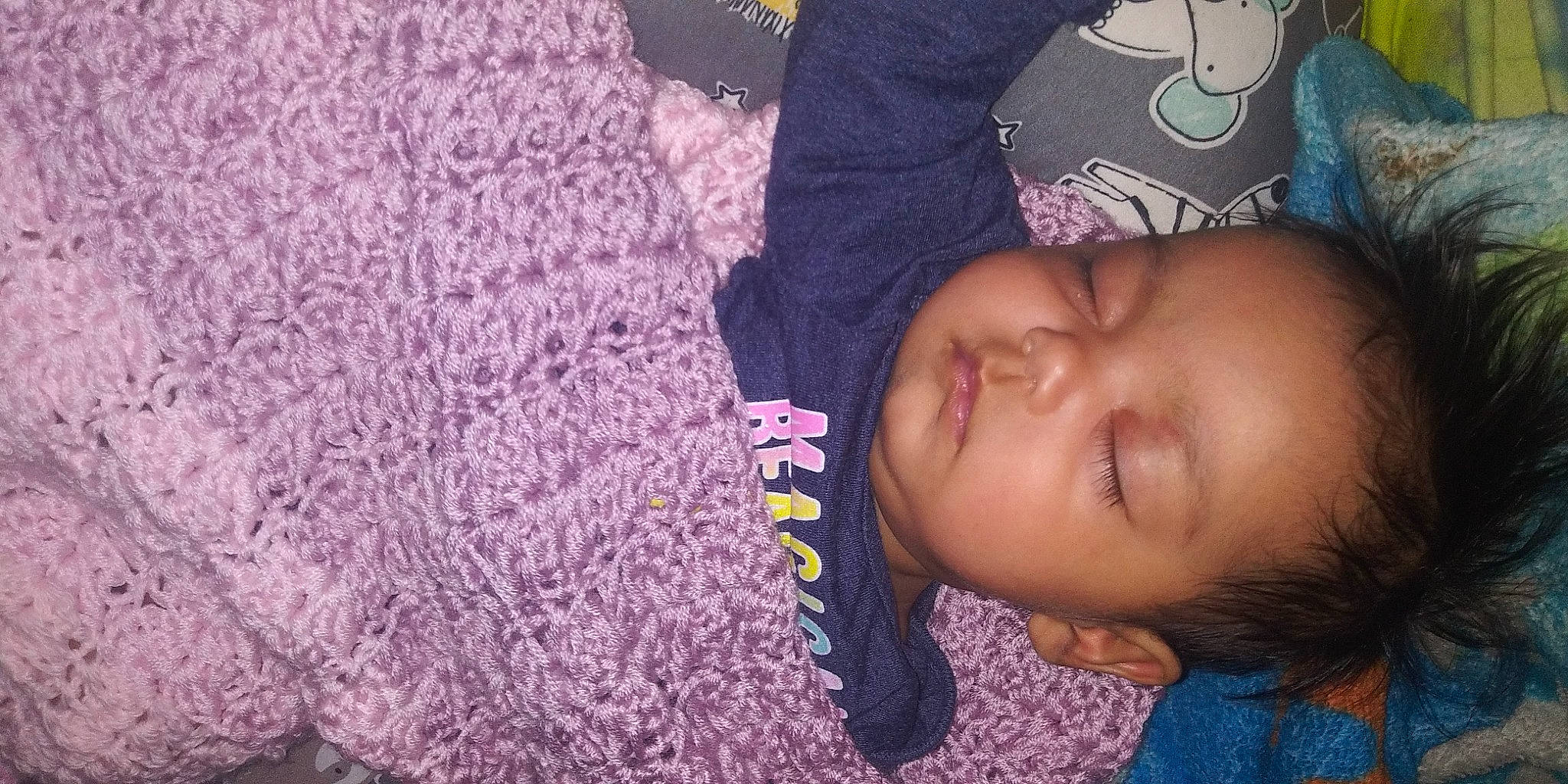 Nymeriah is registered to the contest to win money with this photo: baby, black_hair, cheek, child, forehead, lavender, nap, nose, person, pink, purple, skin, sleep, smile, textile, toddler, violet