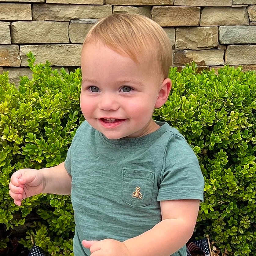 Nathan is registered to the contest to win money with this photo: architecture, baby, backyard, building, clothing, face, head, herbal, herbs, nature, outdoors, person, photography, plant, portrait, pottedplant, rock, t_shirt, wall, yard