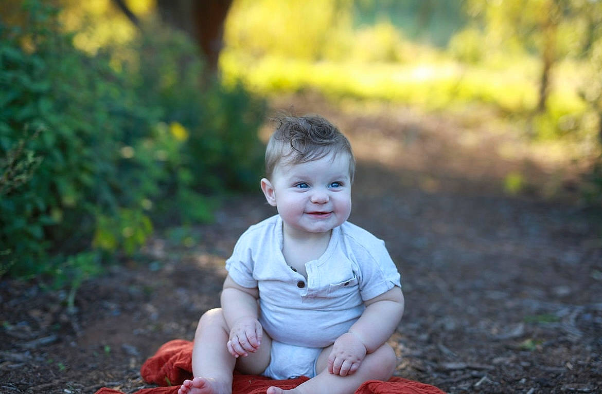 Jaxon is registered to the contest to win money with this photo: baby, baby_toddler_clothing, child, eye, flash_photography, flooring, fun, garden, grass, happy, head, joy, people_in_nature, person, plant, portrait_photography, sitting, smile, soil, t_shirt
