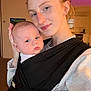 Sawyer is registered to the contest to win money with this photo: woman, baby, indoor, selfie, baby_carrier, freckles, face, human, parent, child, skin, hair, black_clothing, white_clothing, living_space, kitchen, light, expression, closeup, tender_moment