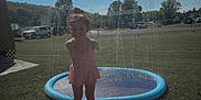 Macie joined the competition — help win amazing prizes! child, girl, swimsuit, water_splash, splash_pool, smile, outdoor, sunny, grass, backyard, trees, house, car, summer, play, fun, water, recreation, happy, daytime