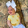 Brandi joined the competition — help win amazing prizes! baby, smiling, headband, bow, yellow_shirt, lemon_pattern, white_pants, couch, floral_pattern, infant, happy, cute, child, portrait, indoors, fabric, soft_lighting, face, person, sitting