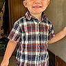 background, blonde_hair, boy, casual, child, clothing, cute, face, hair, happy, home, indoors, jeans, person, plaid_shirt, portrait, short_sleeve, smile, standing, young