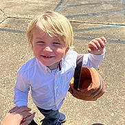 Wayland Bragg joined the competition — help win amazing prizes! child, blonde_hair, white_shirt, jeans, blue_shoes, pumpkin_basket, hand_holding, outdoor, concrete, sunlight, smiling, person, daylight, casual_clothing, young_child, holding_basket, playful, toddler, happy, bright