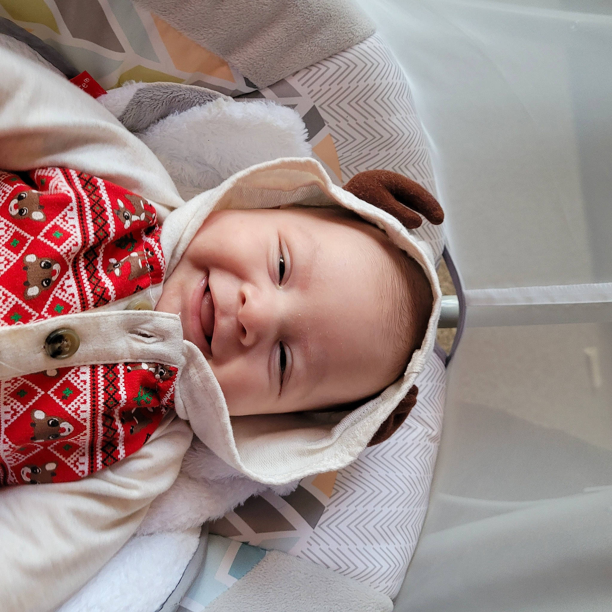 Jose is registered to the contest to win money with this photo: baby, baby_products, baby_toddler_clothing, car_seat, cheek, child, comfort, eyelash, fashion_accessory, happy, hat, linens, lip, pattern, person, portrait_photography, skin, sleeve, smile, toddler