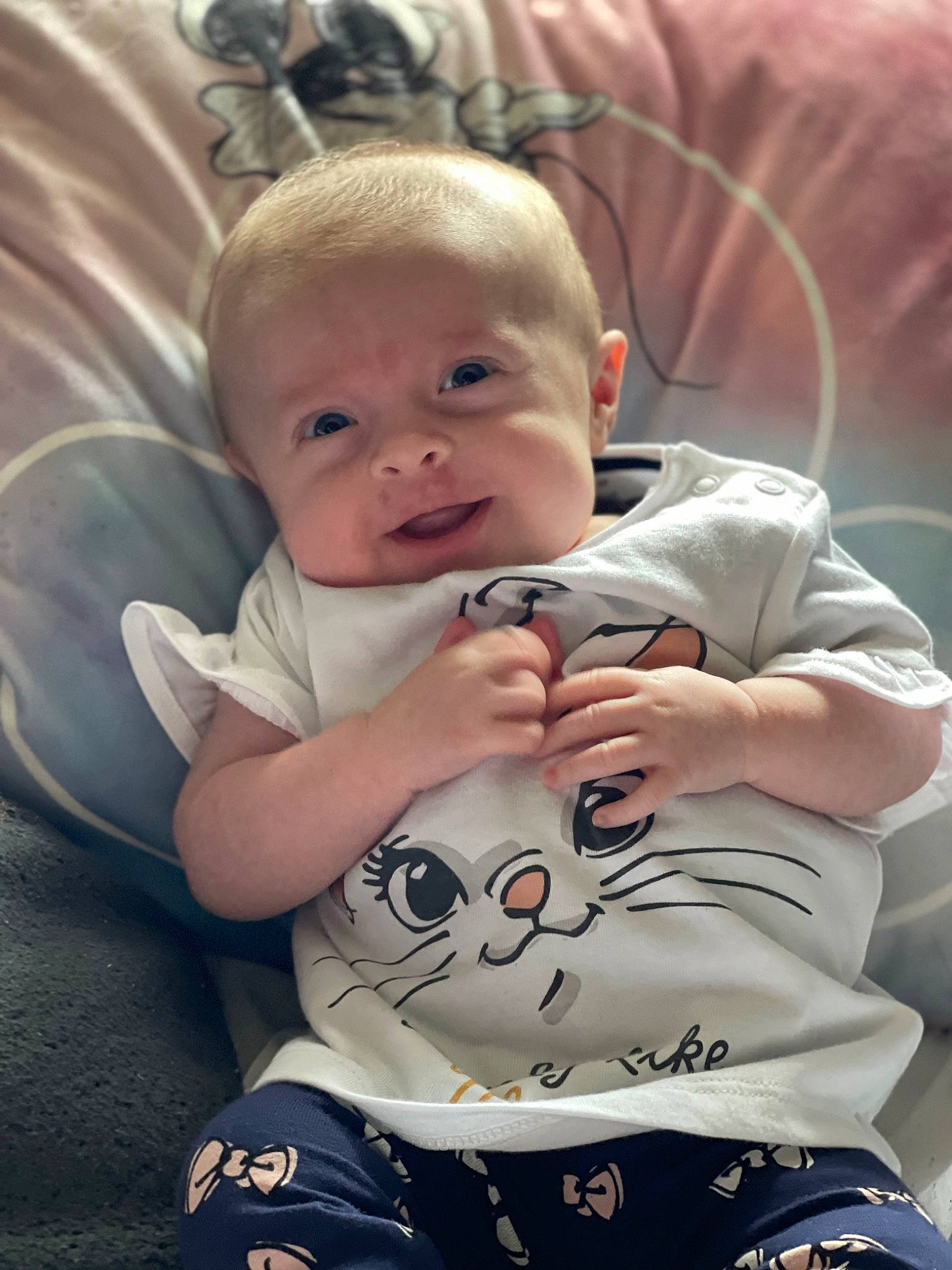 Amy is registered to the contest to win money with this photo: baby, baby_carriage, baby_products, baby_toddler_clothing, cheek, child, comfort, cool, event, eye, finger, fun, happy, human_body, lap, linens, mouth, person, sitting, skin