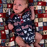 baby, infant, blanket, pattern, colorful, rodeo, outfit, clothing, lying_down, cute, face, head, skin, small_hands, small_feet, expression, indoor, soft_texture, red, blue
