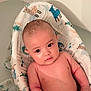Clayton is registered to the contest to win money with this photo: baby, child, bath, water, skin, face, eyes, blanket, animal_pattern, comfort, infant, cute, expression, head, arm, indoors, relaxation, portrait, soft, tub
