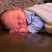 Lennox joined the competition — help win amazing prizes! baby, newborn, sleeping, blanket, cozy, soft, infant, face, peaceful, closeup, couch, rest, comfort, child, skin, hand, head, warm, portrait, indoors