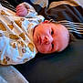 baby, bear_pattern, bed, blanket, clothing, cute, face, head, indoors, infant, infant_face, lying_down, newborn, onesie, person, resting, skin, sleepwear, small_hand, soft