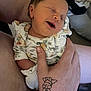 newborn, baby, infant, smiling, sleeping, hand, tattoo, floral_clothing, person, indoor, closeup, skin, cute, holding, relaxation, comfort, family, portrait, young_child, human