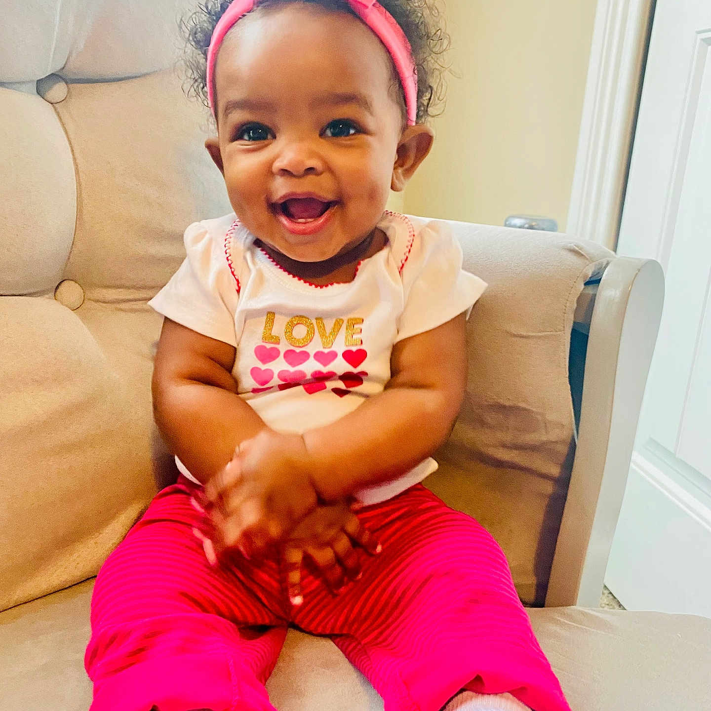 Ravyn is registered to the contest to win money with this photo: accessories, architecture, baby, babylaughing, ball, bodypart, bracelet, building, chair, clothing, couch, cushion, door, dress, earring, face, football, footwear, furniture, glasses