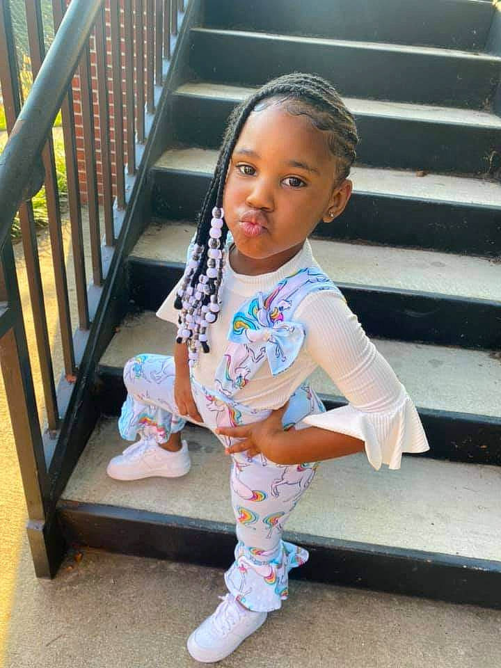 Zariyah is registered to the contest to win money with this photo: baby_toddler_clothing, beauty, child, cool, design, eye, foot, happy, human_leg, knee, leisure, pattern, person, sitting, sleeve, smile, sock, t_shirt, thigh, toddler