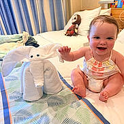 Everleigh joined the competition — help win amazing prizes! baby, towel, elephant, bed, smiling, child, indoor, toy, pillow, curtains, fabric, furniture, cute, happy, person, infant, room, decor, clothing, soft