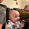 Osiris joined the competition — help win amazing prizes! baby, child, infant, adult, faces, portrait, smiling, curious, sitting, couch, leather, indoors, family, home, clothing, strap, toy, stocking, cozy, photography