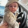 Enoan participe au concours pour gagner de l'argent avec cette photo : baby, child, hoodie, car, steering_wheel, hand, window, face, curious, seated, clothing, indoor, person, transportation, vehicle, casual, portrait, cute, support, young