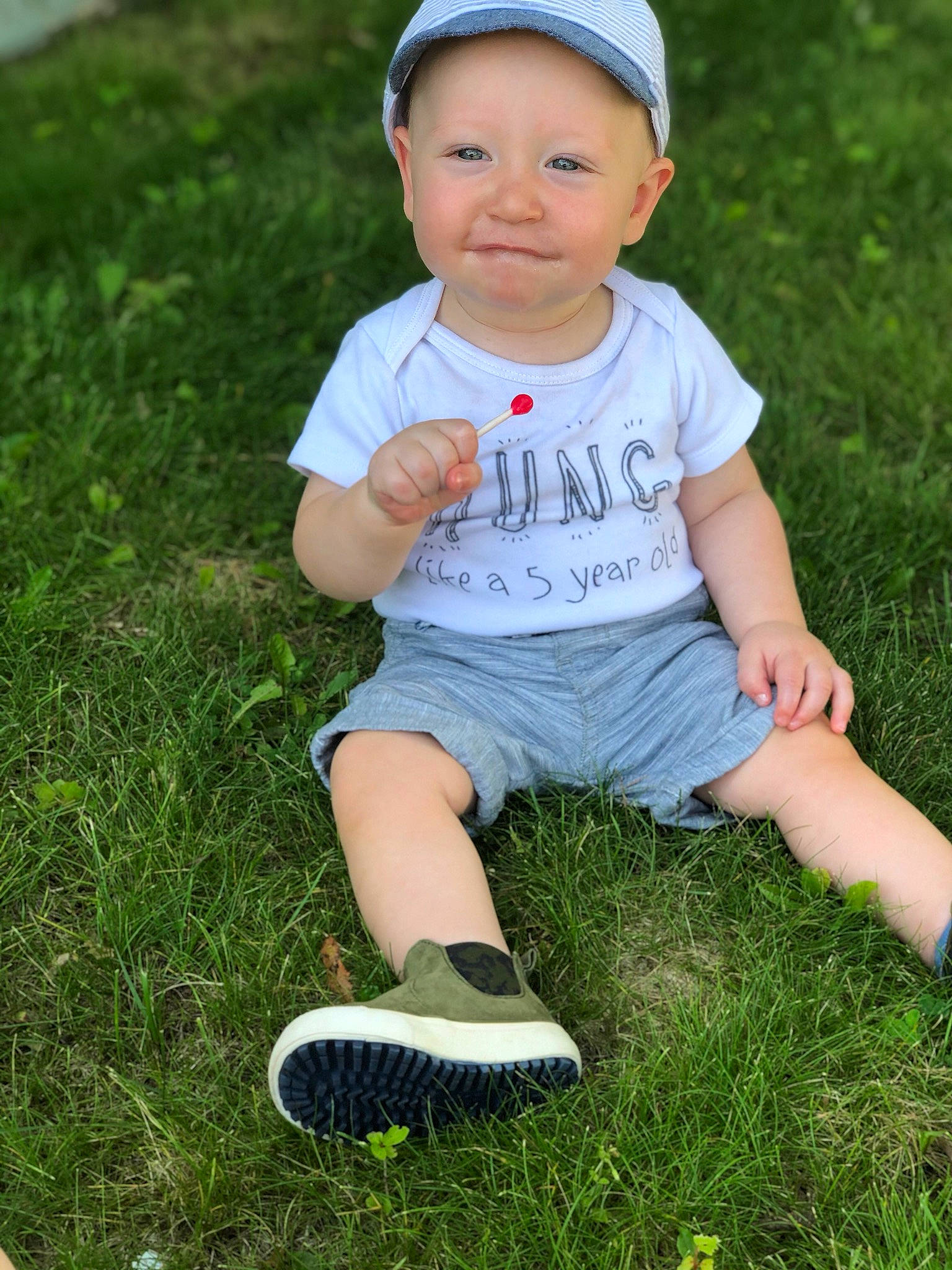 Hartley is registered to the contest to win money with this photo: baby, baby_toddler_clothing, child, child_model, fun, grass, grass_family, green, happy, head, headgear, headwear, joy, lawn, person, photography, plant, play, sitting, skin